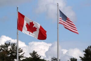 Canadian and American flags waving.