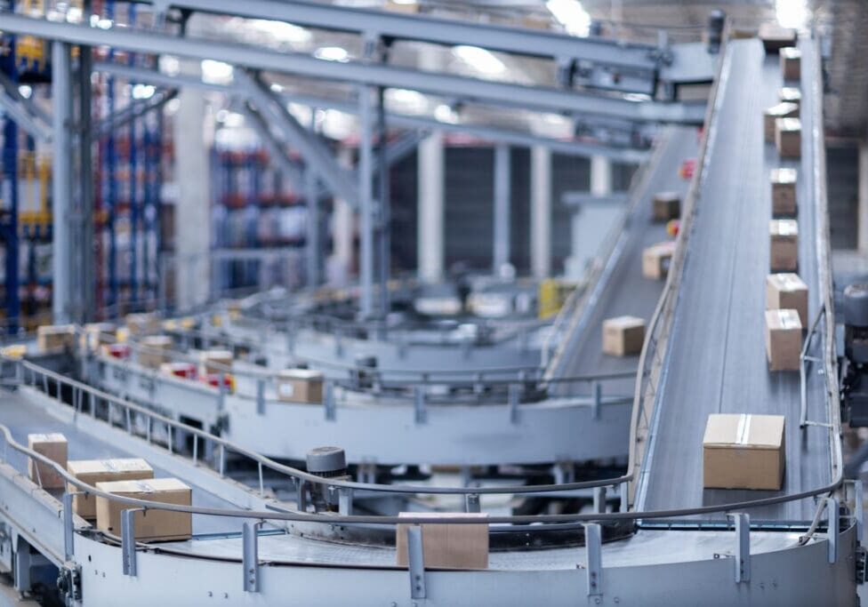 View of modern conveyor belts transporting boxes in a large warehouse ready for delivery. logistics.