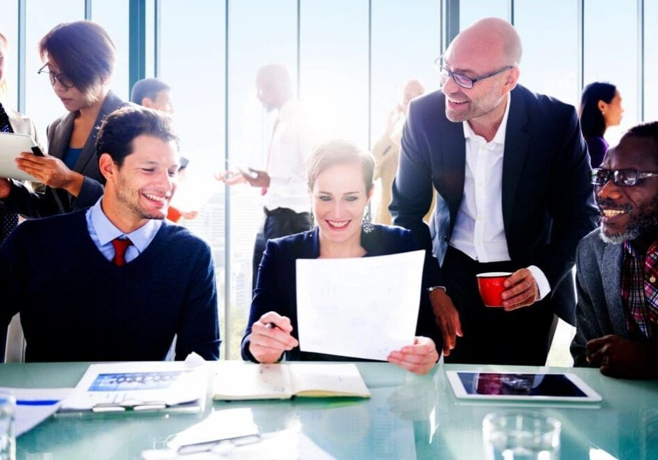 Businesspeople reviewing documents in meeting.