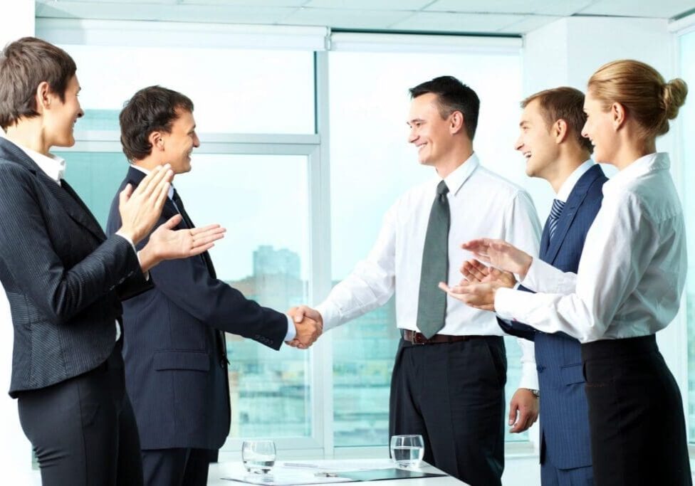 Business colleagues applauding a handshake.