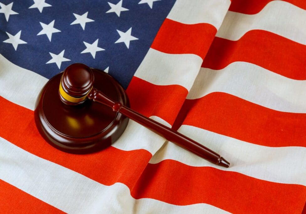 Judge gavel adorned with American flag represents legal system in United States