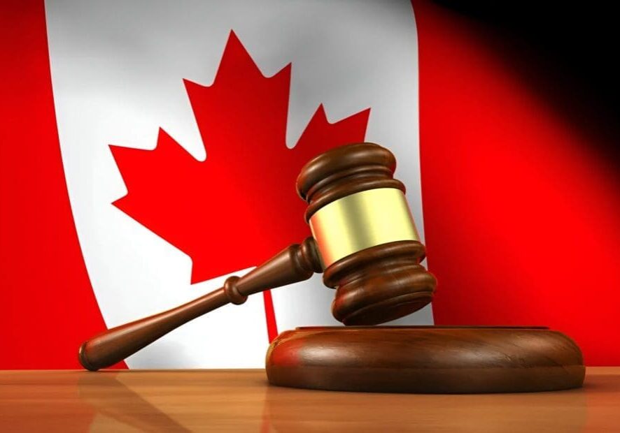 A judge's gavel rests on a sound block in front of a Canadian flag, like a symbol of order and authority, reminiscent of how a Library Page maintains the organization and flow within the quiet sanctum of knowledge.